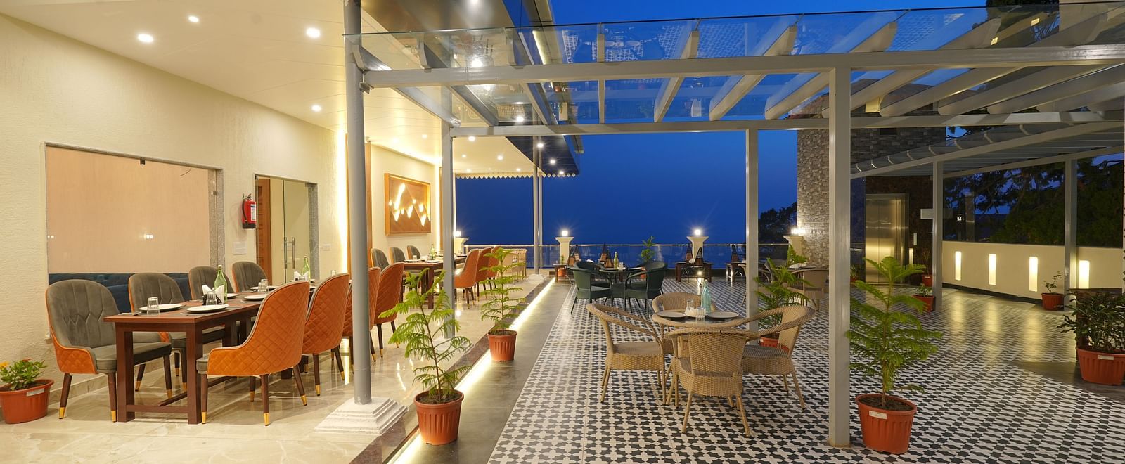 Rooftop dining area during the evening at DLS Oak Bush, Mussoorie.