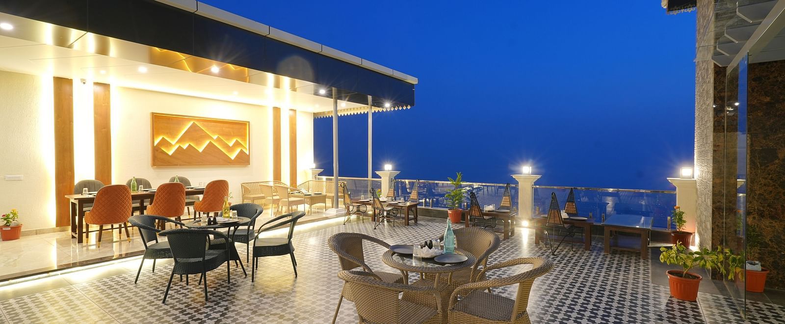 Rooftop dining area during the evening at DLS Oak Bush, Mussoorie.