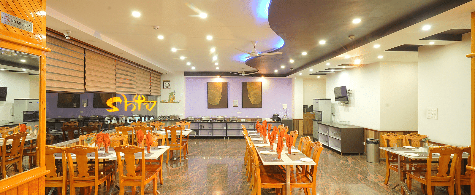 A wide angle shot of the dining area of the hotel with numerous tables and chairs | DLS Hotel Shiva Sanctuary & Spa, Dharamshala