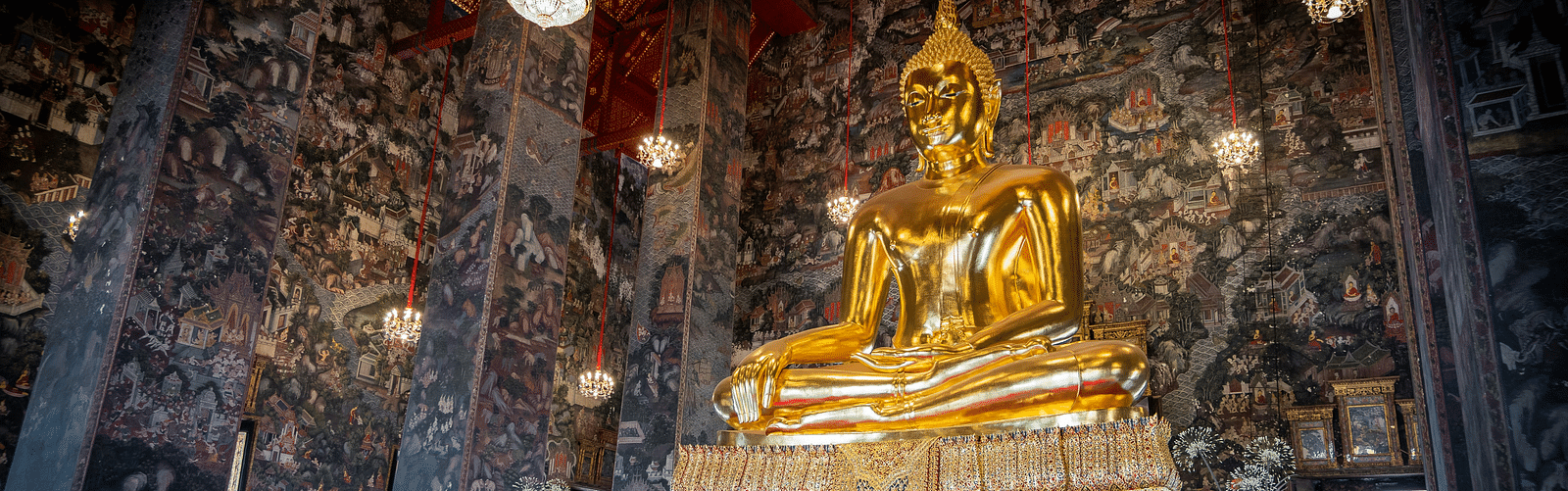 An overview of a temple with a golden statue in view in a sitting position - Erawan Shrine Hotel