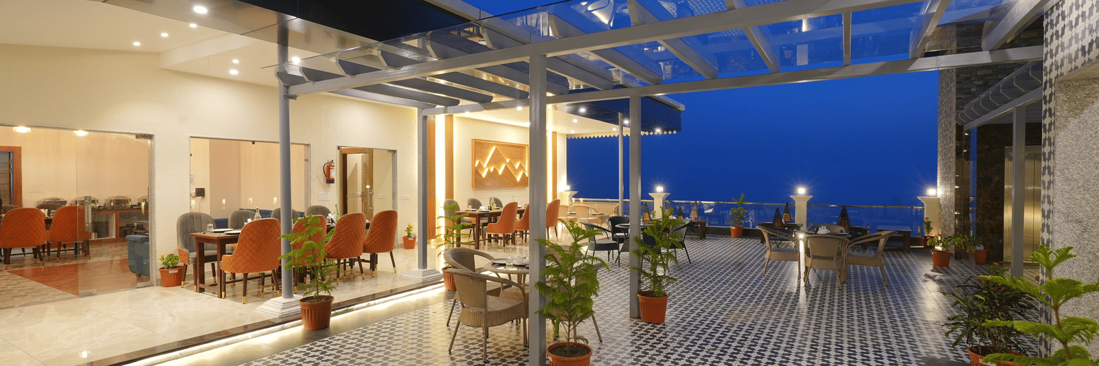 Rooftop dining area during the evening at DLS Oak Bush, Mussoorie.