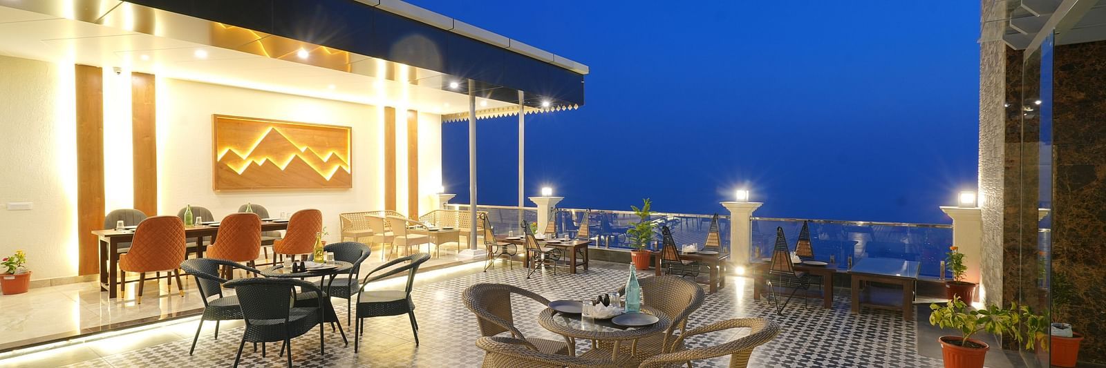 Rooftop dining area during the evening at DLS Oak Bush, Mussoorie.