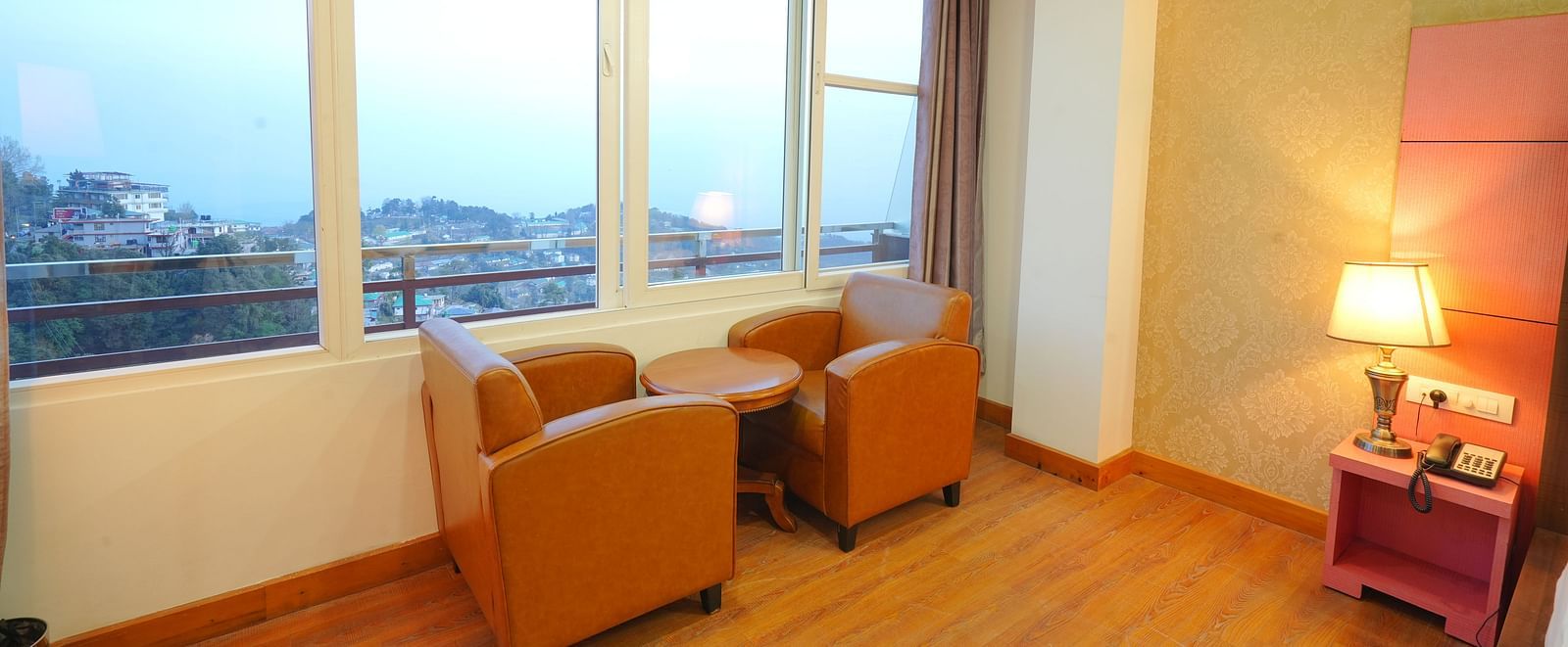 A cosy seating area in a hotel room with two armchairs and a small table | DLS Hotel Shiva Sanctuary & Spa, Dharamshala
