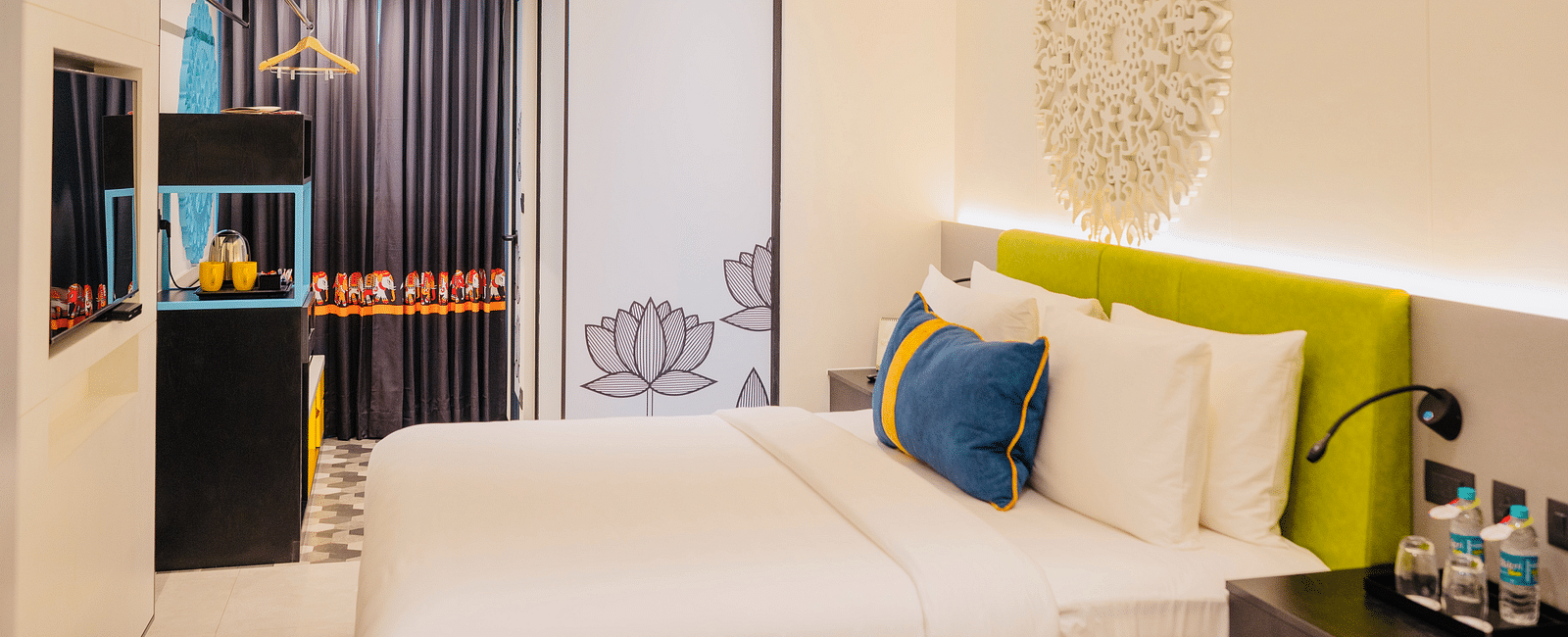 side view of a bedroom with tea and coffee maker at Zibe Luxe Kakinada by GRT Hotels