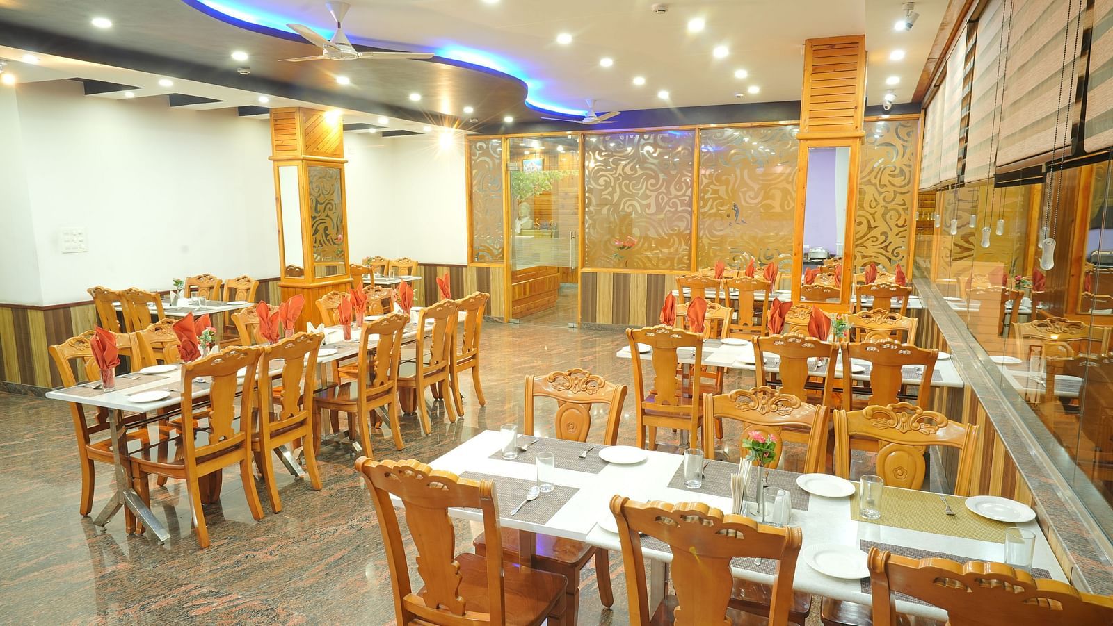 A close up shot of the restaurant with different table and chairs | DLS Hotel Shiva Sanctuary & Spa, Dharamshala