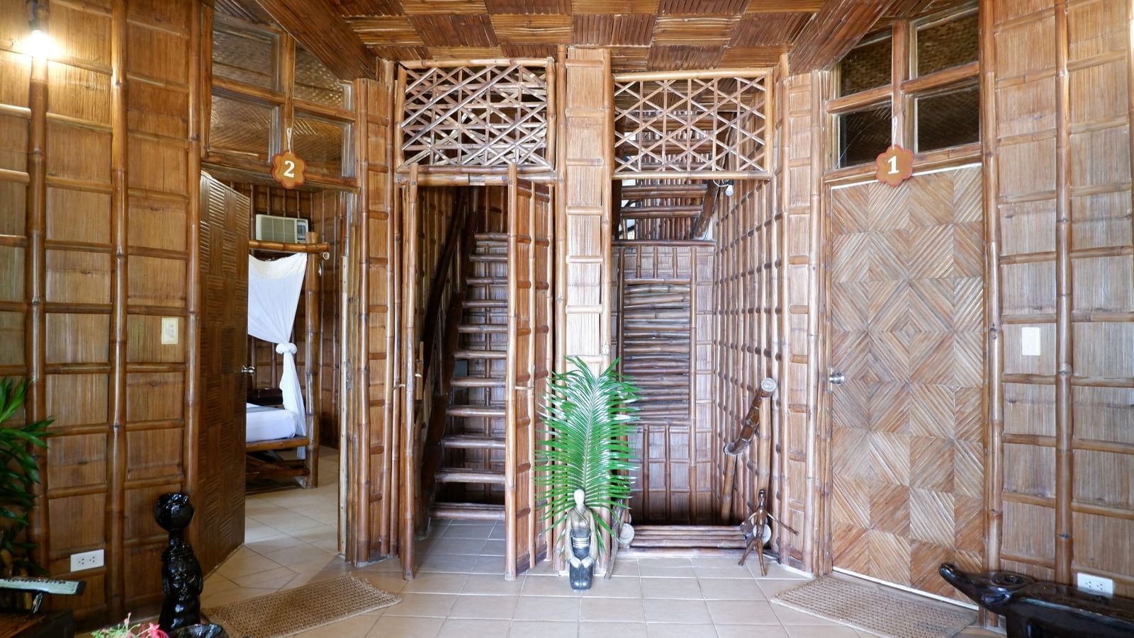 Tiled entranceway with bamboo accents and staircase at Flower Island Resort.  
