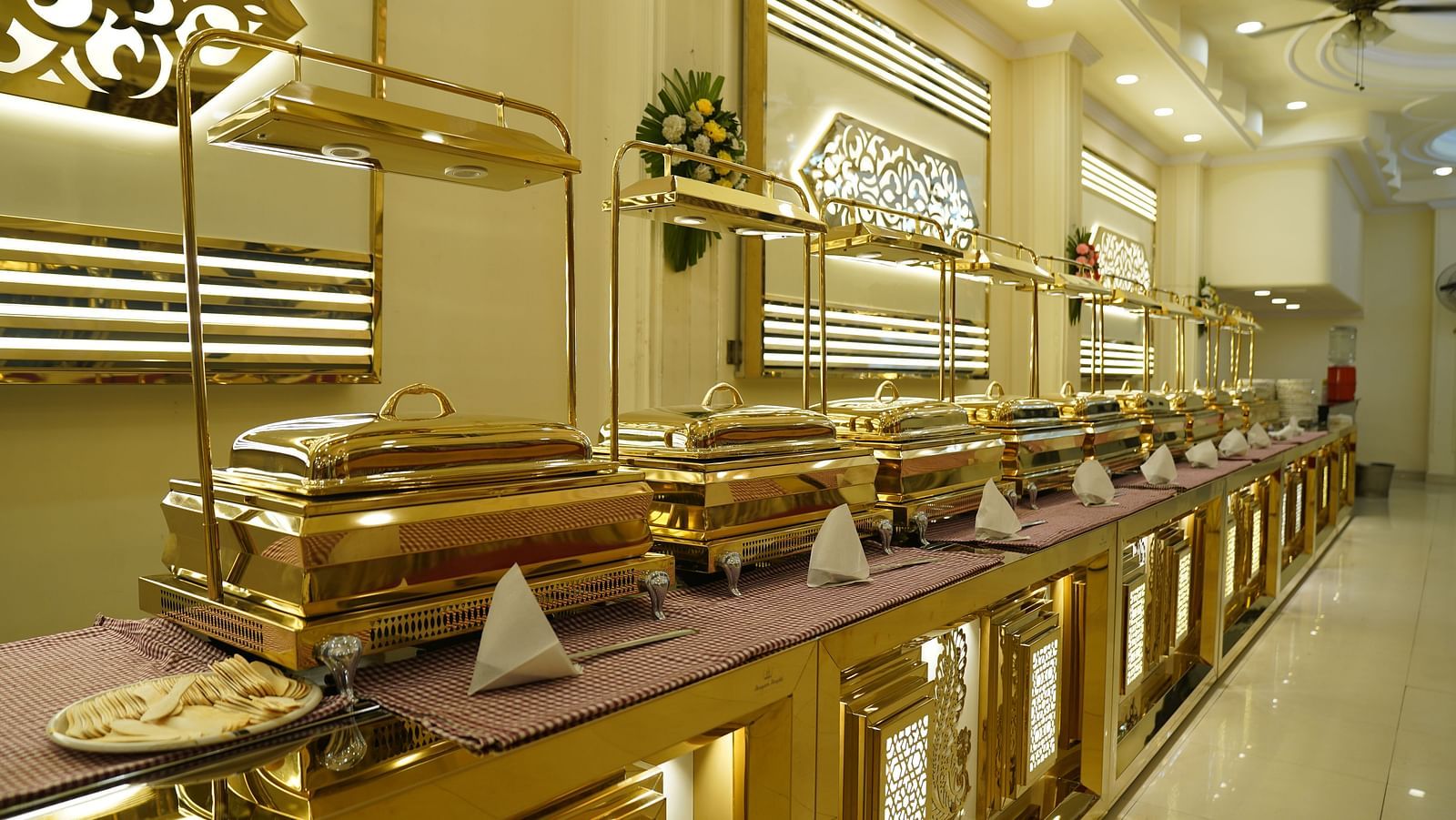 A photograph of a banquet hall in Roorkee featuring a chandelier and a buffet setup - Motel Divine International, Roorkee