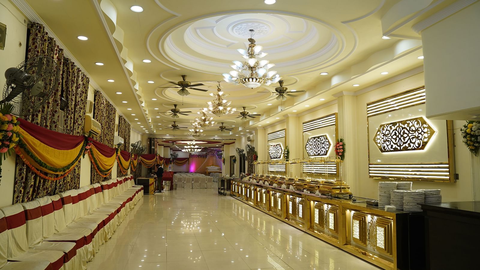 A photograph of a banquet hall in Roorkee featuring a chandelier and a buffet setup - Motel Divine International, Roorkee
