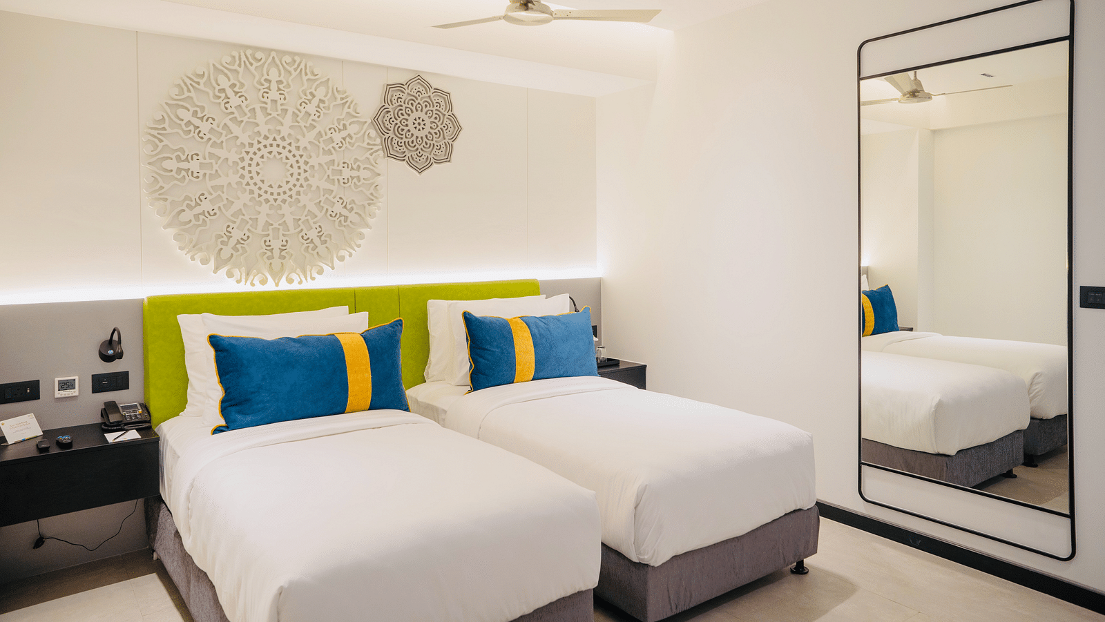 an image of the twin bedroom with well crafted headboard at Zibe Luxe Kakinada by GRT Hotels