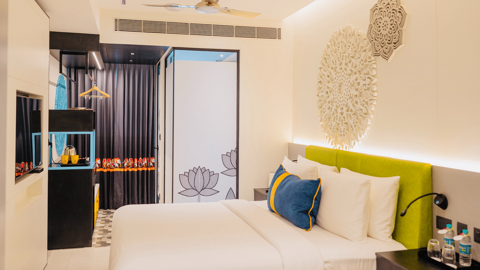 side view of a bedroom with tea and coffee maker at Zibe Luxe Kakinada by GRT Hotels