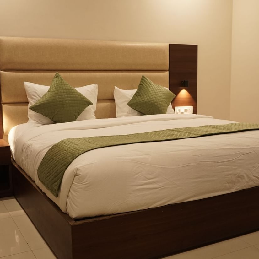 Superior room at Five Elements Hotels, Haridwar, featuring a king-sized bed with bedside lamps