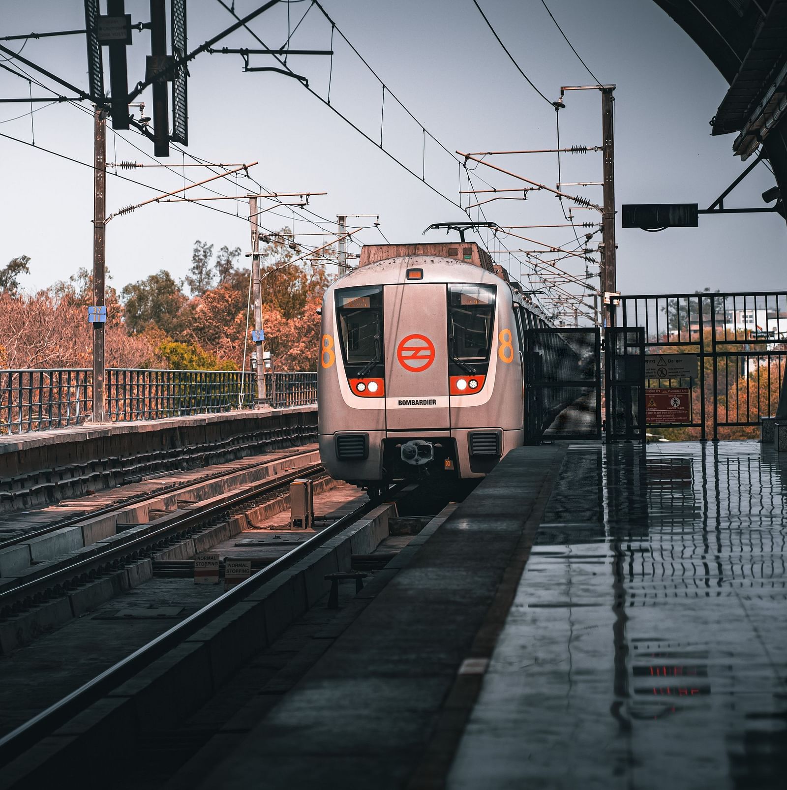 a train travelling on a track coming near a station