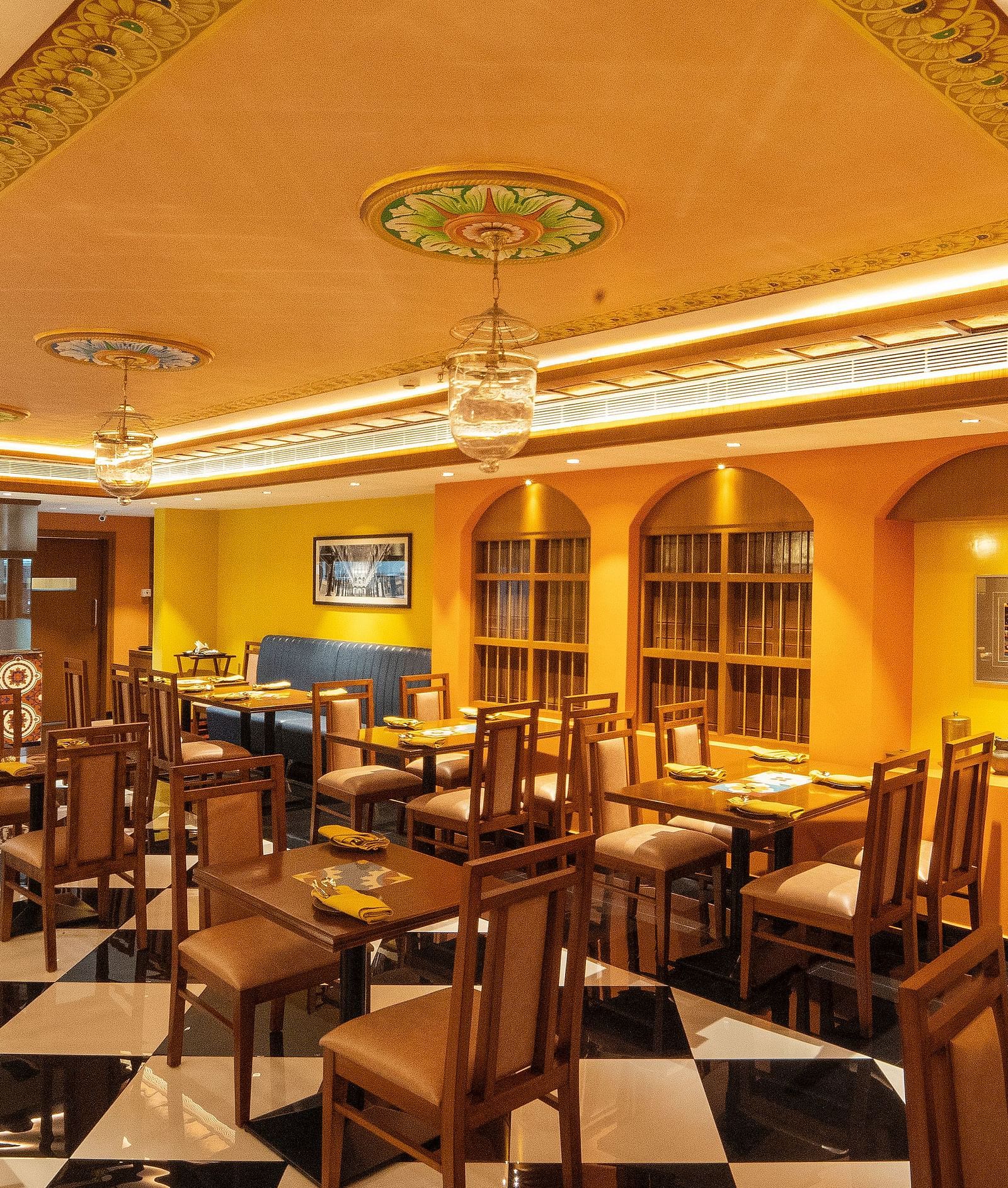 image of the chettinad stories with well defined seating arrangements for dining at hotel aadithya, chennai
