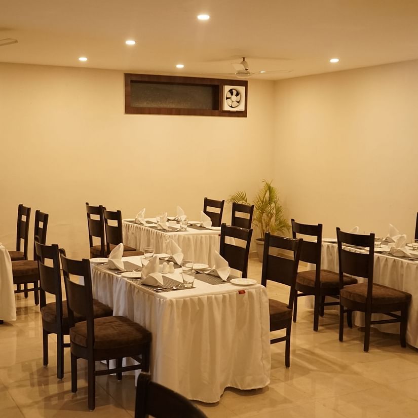 Image of the cafe at Five Elements Hotels, Haridwar, showcasing neatly arranged tables and chairs