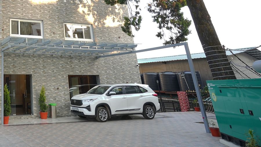 Facade view of DLS Oak Bush, Mussoorie with car parked outside.