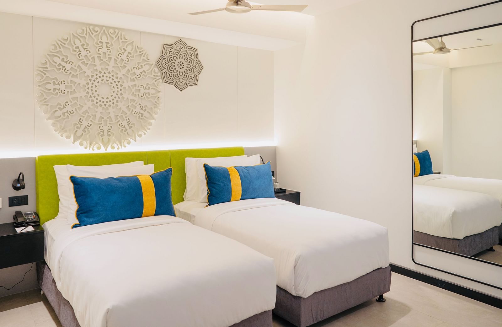 an image of the twin bedroom with well crafted headboard at Zibe Luxe Kakinada by GRT Hotels