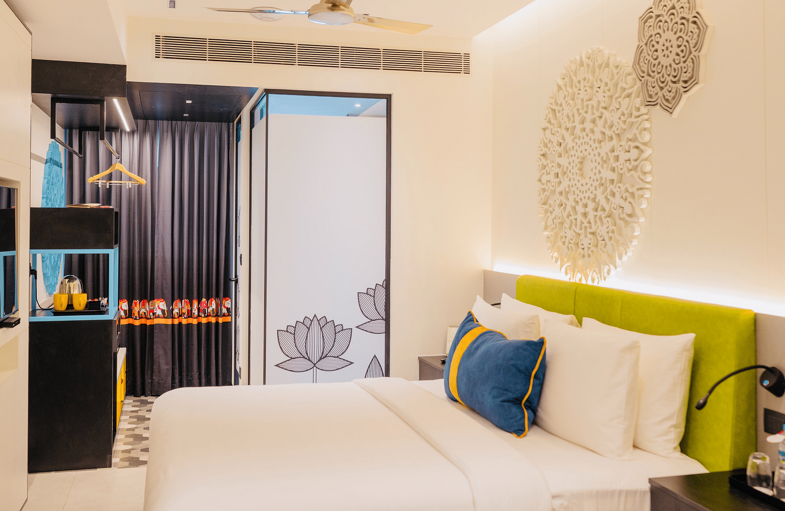 side view of a bedroom with tea and coffee maker at Zibe Luxe Kakinada by GRT Hotels
