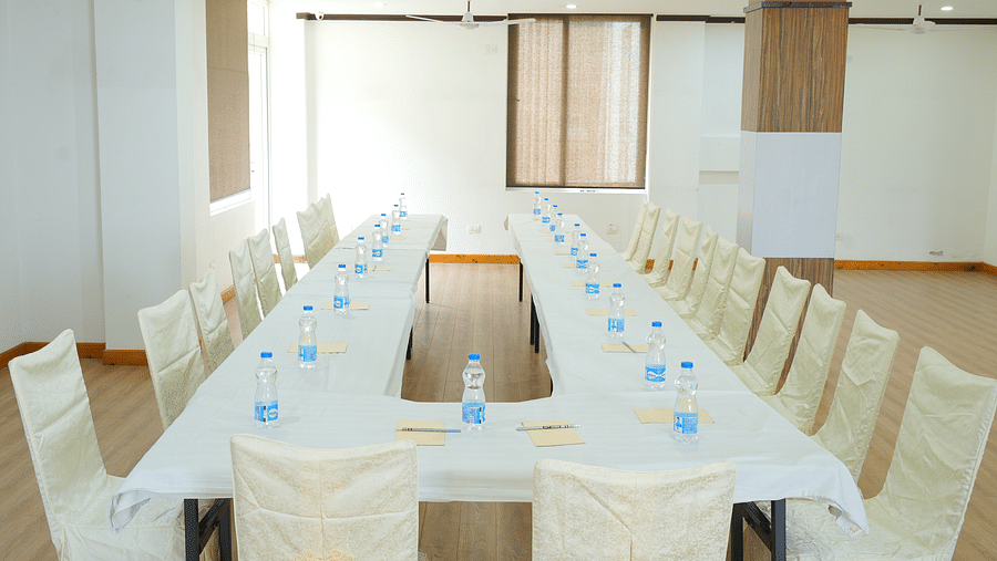 Image of a  conference room with a long, rectangular table and chairs set up for a meeting | DLS Hotel Shiva Sanctuary & Spa, Dharamshala