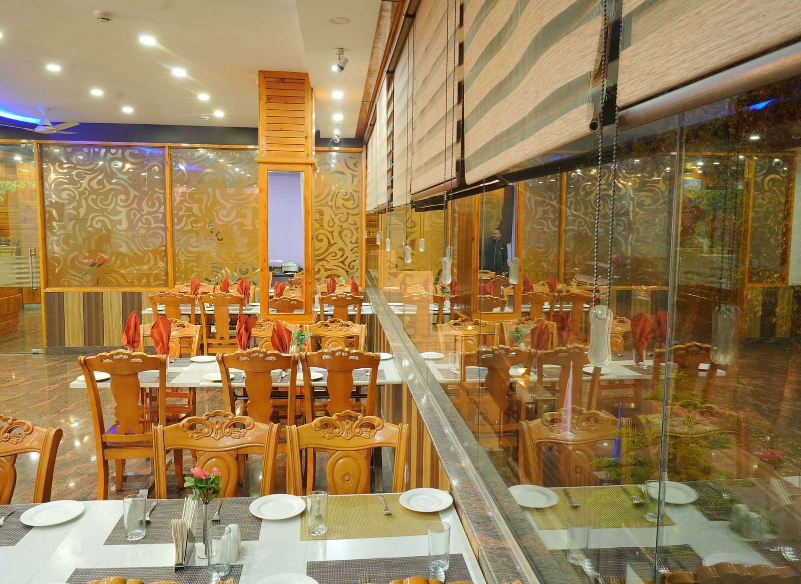  A closeup shot of the restaurant with several chairs and table arranged | DLS Hotel Shiva Sanctuary and Spa
