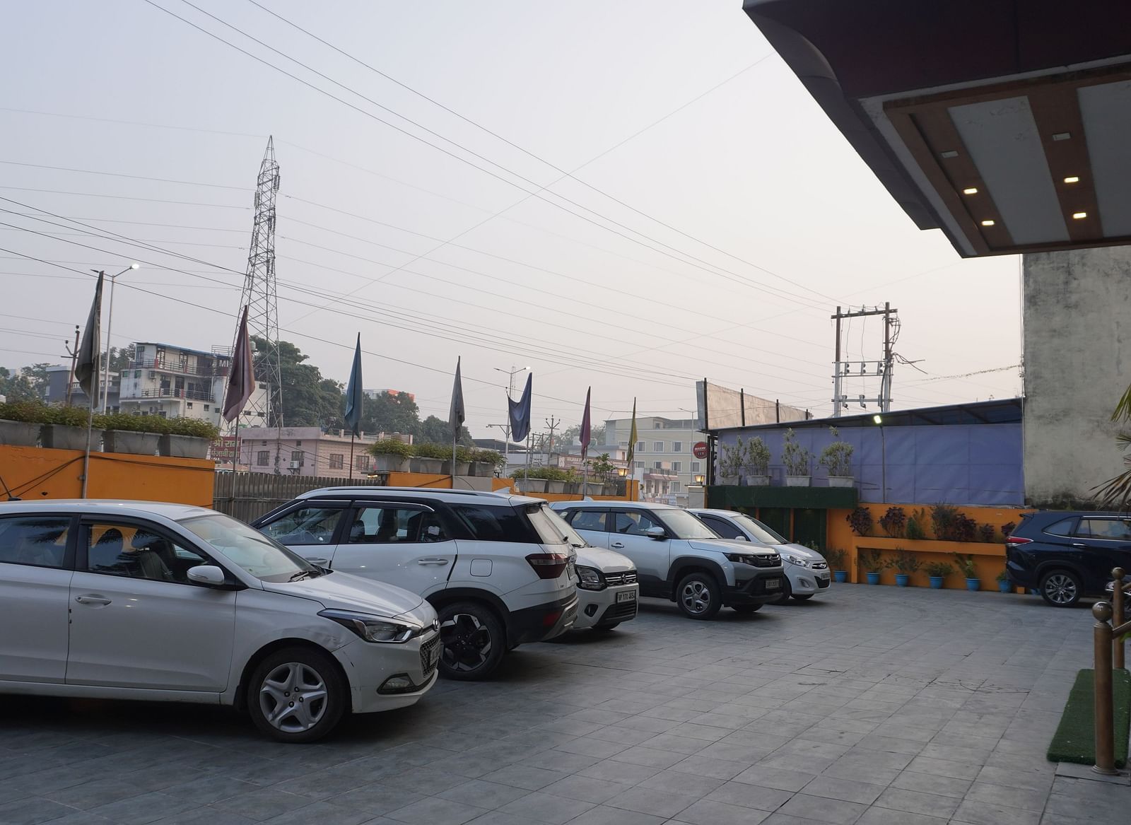A row of cars parked in a lot outside of a building | DLS Park Grace, Haridwar