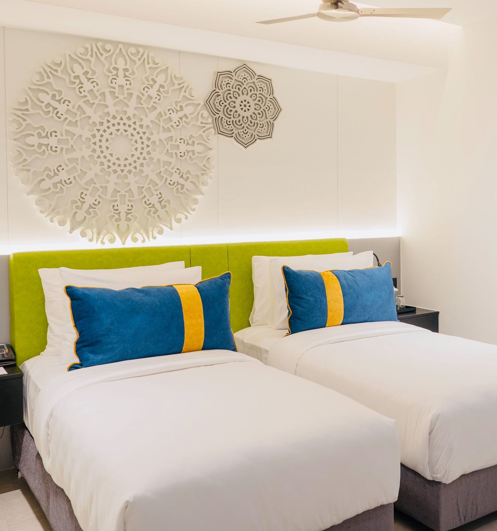 an image of the twin bedroom with well crafted headboard at Zibe Luxe Kakinada by GRT Hotels