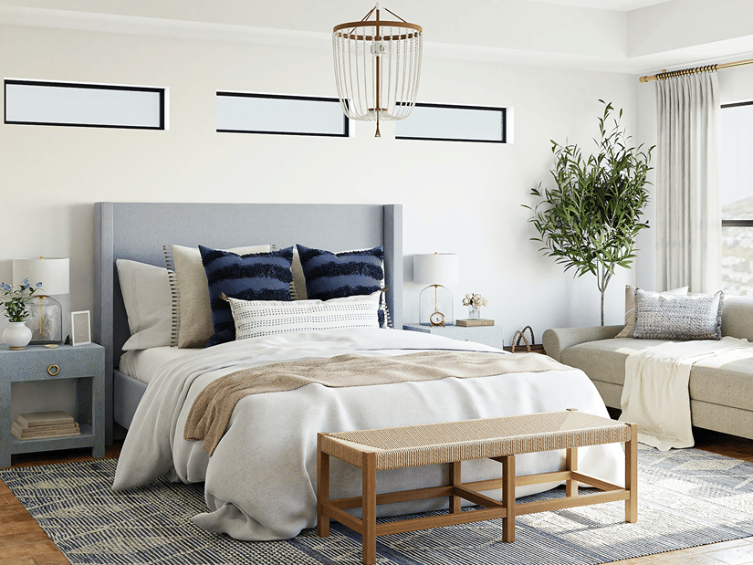 an image of a bedroom featuring a bed, side table and a sofa placed by a window