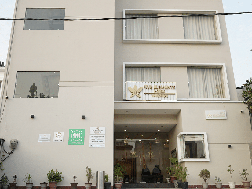 Facade of Five Elements Hotels, Haridwar, featuring the entrance pathway leading to the hotel