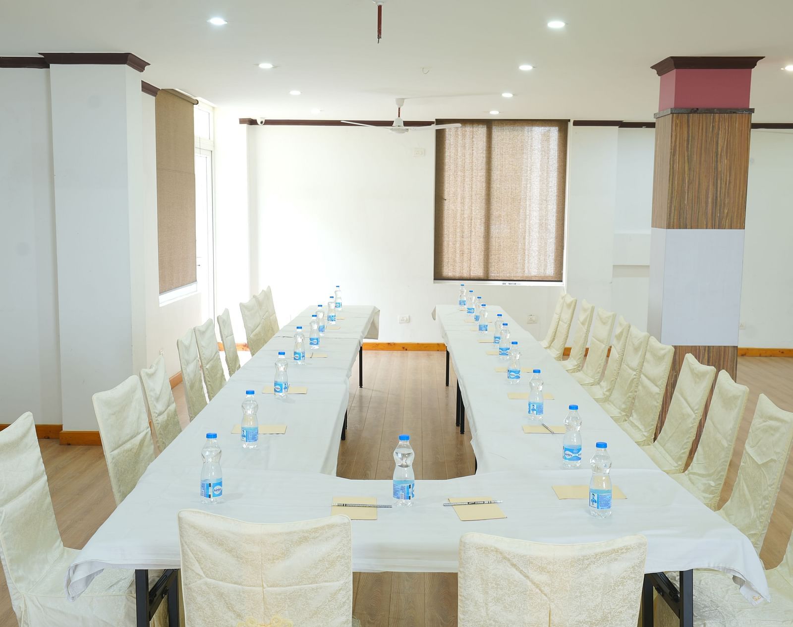 Image of a  conference room with a long, rectangular table and chairs set up for a meeting | DLS Hotel Shiva Sanctuary & Spa, Dharamshala