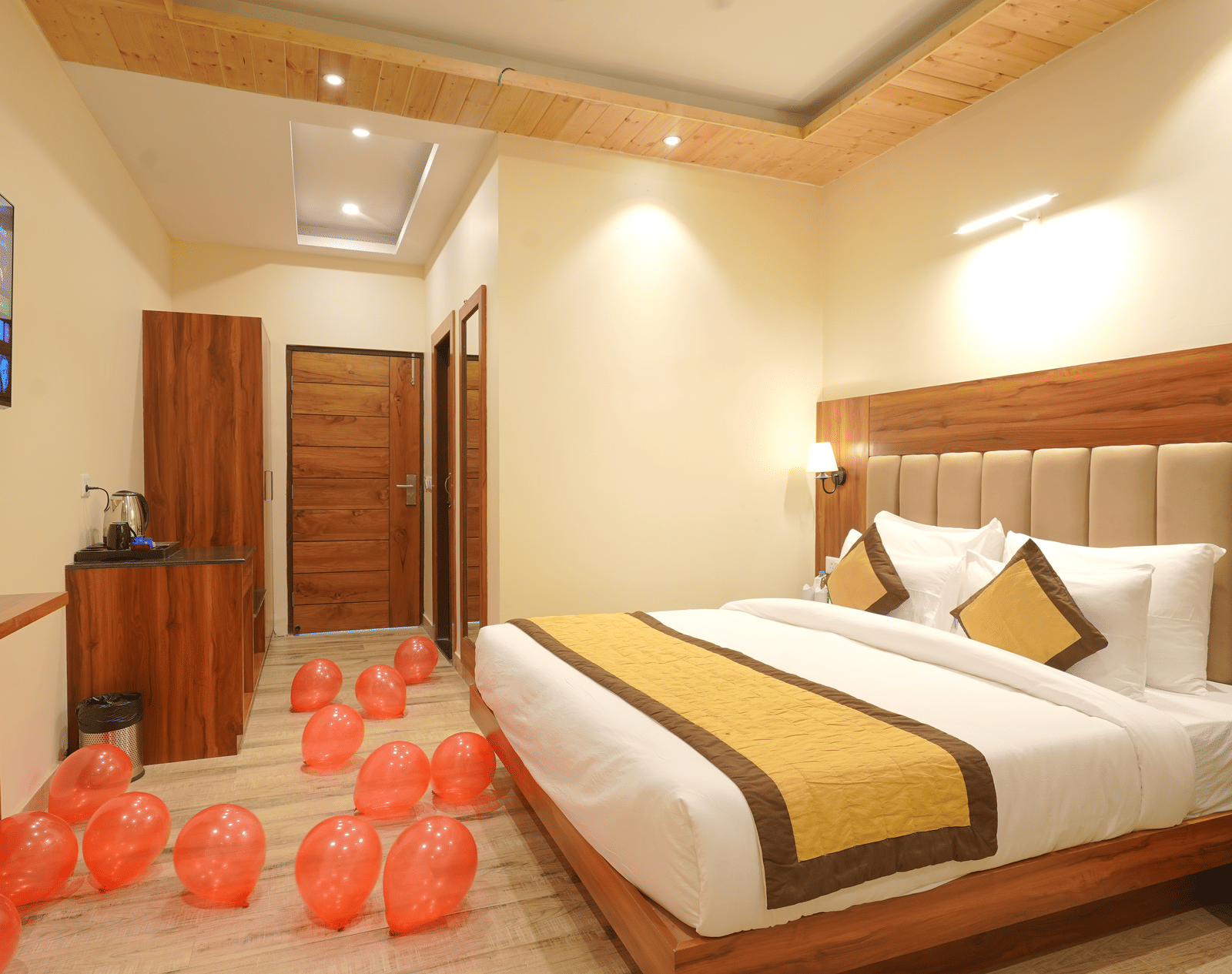 A large bed in front of the TV Deluxe Room at DLS Oak Bush, Musssoorie.