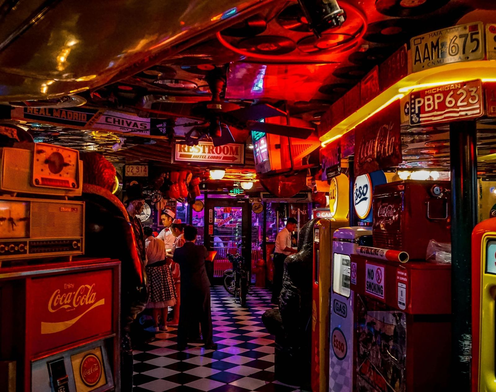 A bustling arcade with neon signs and vintage decor.