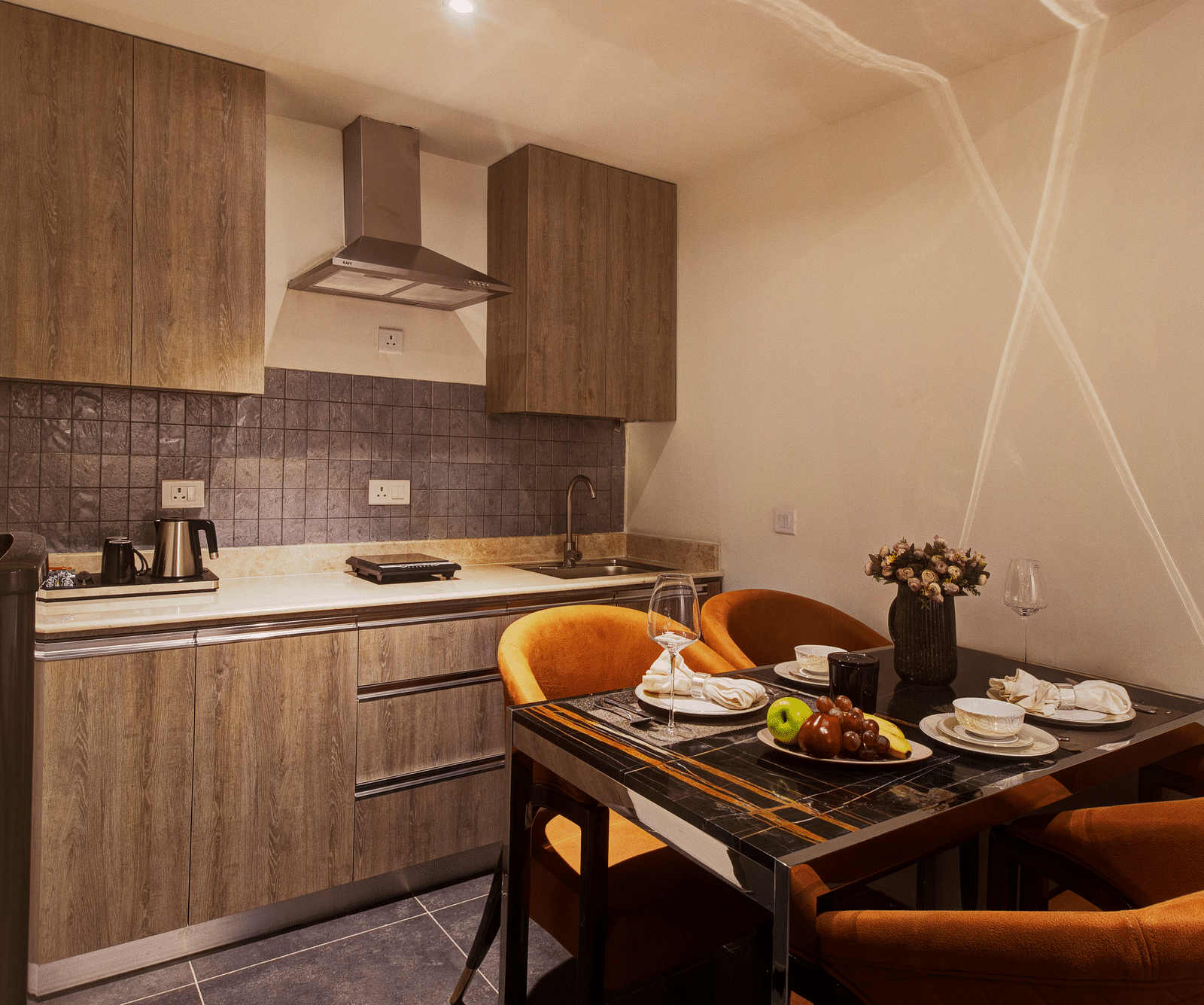 a dining table with a kitchen in the background of Two bedroom Executive Suite - Rhythm Gurugram