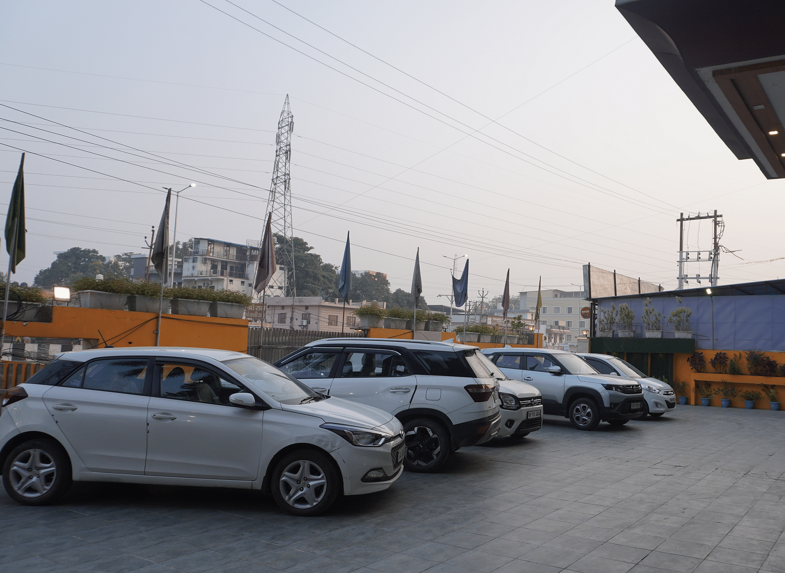 A row of cars parked in a lot outside of a building | DLS Park Grace, Haridwar