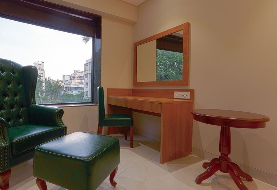 High Back Chairs and a table in a room with a window