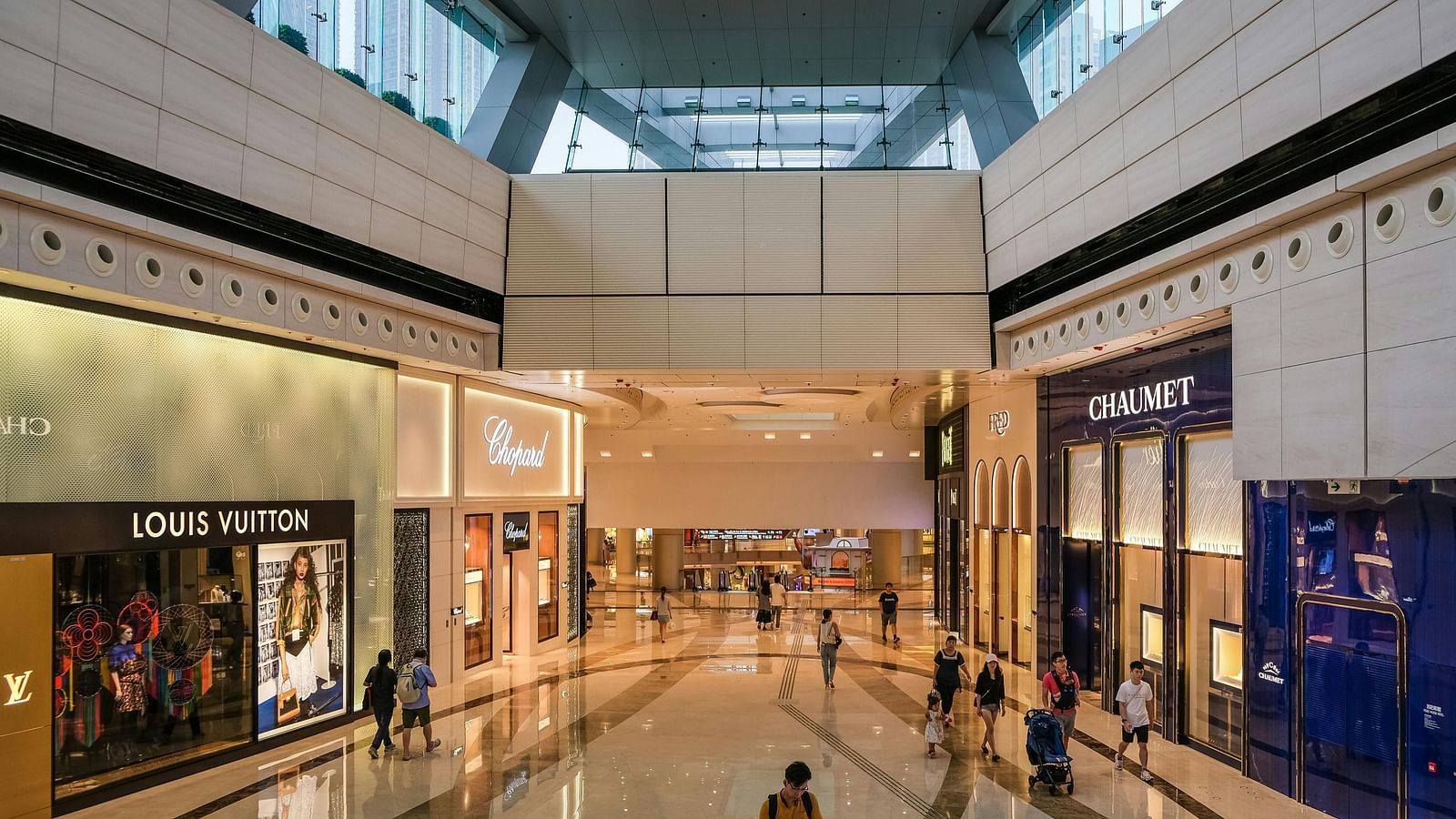 An overview of a shopping mall with many clothing shops in view.
