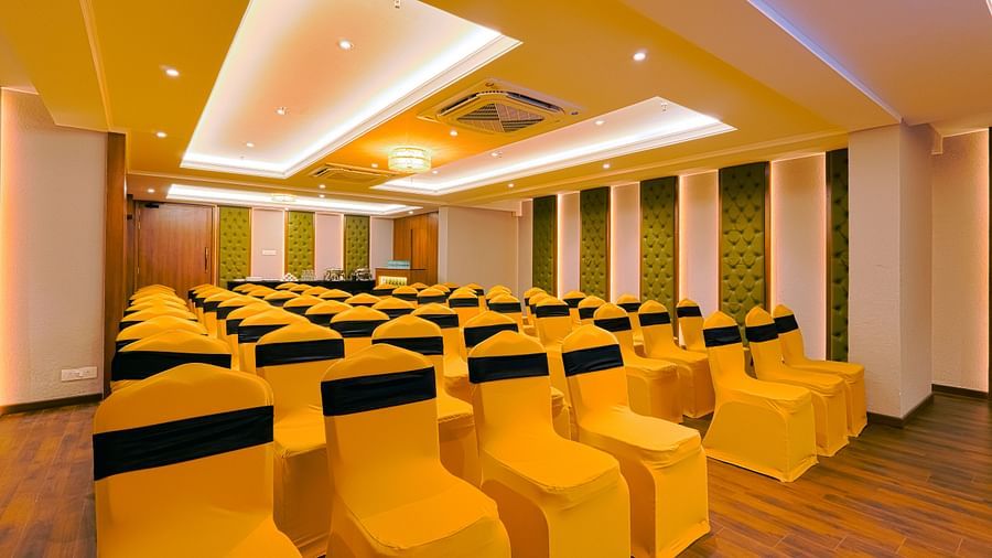Angled view of a spacious conference hall with chairs facing the stage area.