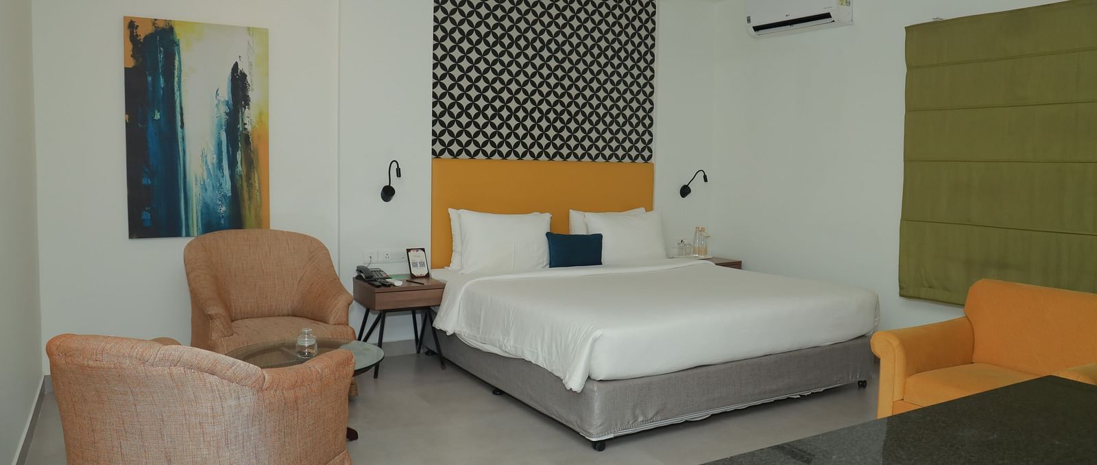 A Suite in Regency Tuticorin by GRT Hotels featuring a large bed and couches on the side and in front - Best Thoothukudi Rooms for Extended Stays