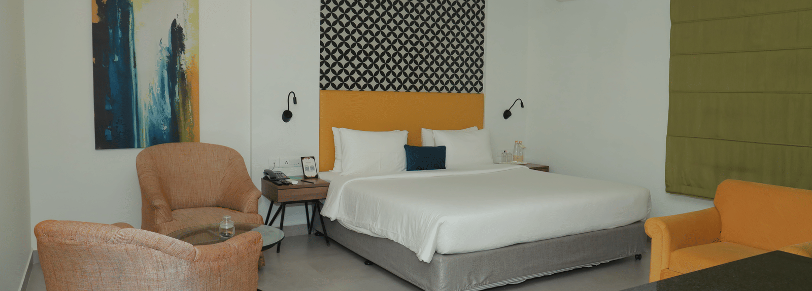 A Suite in Regency Tuticorin by GRT Hotels featuring a large bed and couches on the side and in front - Best Thoothukudi Rooms for Extended Stays