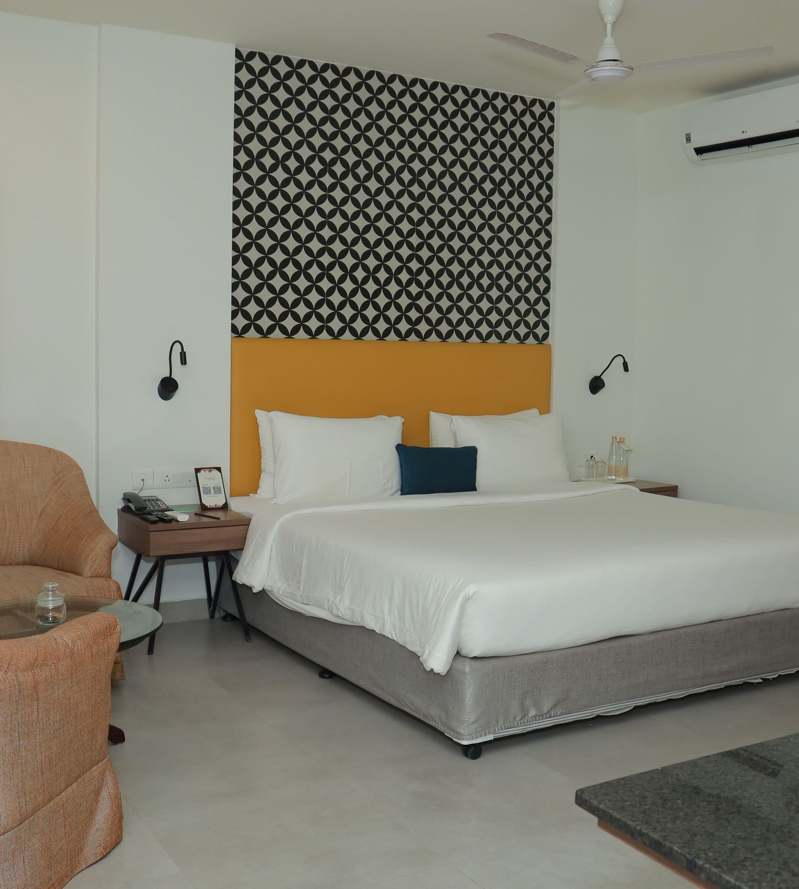 A Suite in Regency Tuticorin by GRT Hotels featuring a large bed and couches on the side and in front - Best Thoothukudi Rooms for Extended Stays
