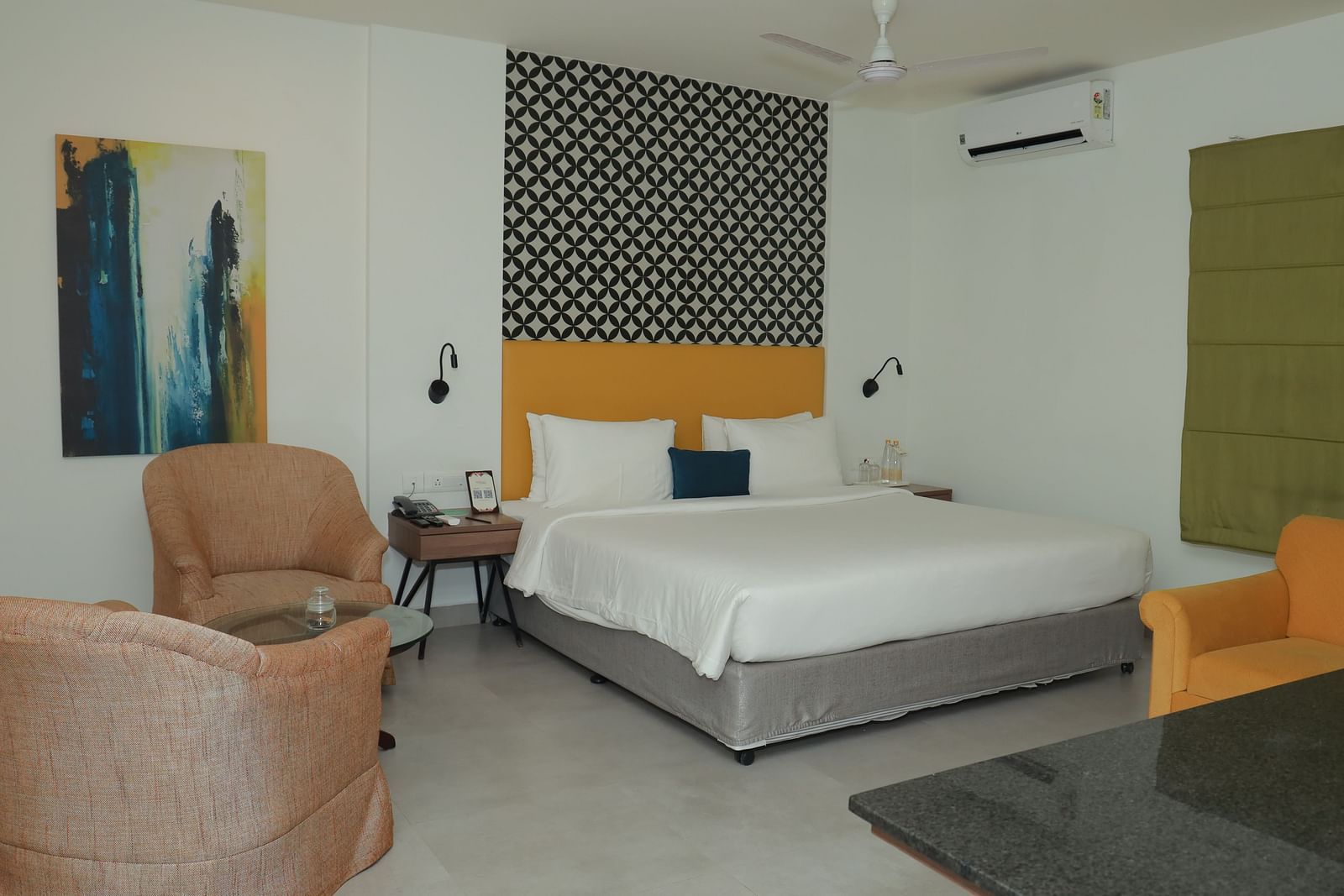 A Suite in Regency Tuticorin by GRT Hotels featuring a large bed and couches on the side and in front - Best Thoothukudi Rooms for Extended Stays