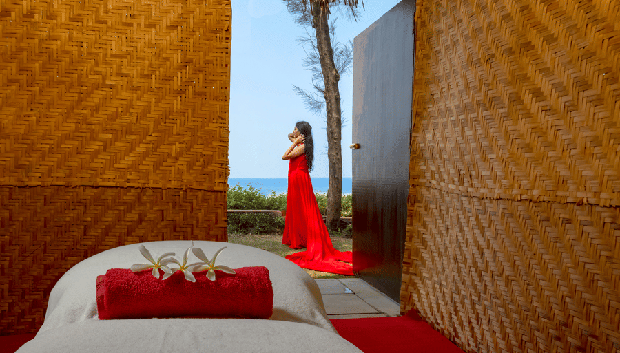 a girl posing for a picture in the distance - Caravela Beach Resort Goa