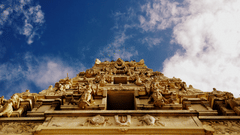 facade image of the vishnu temple as seen from below with blue sky in the background