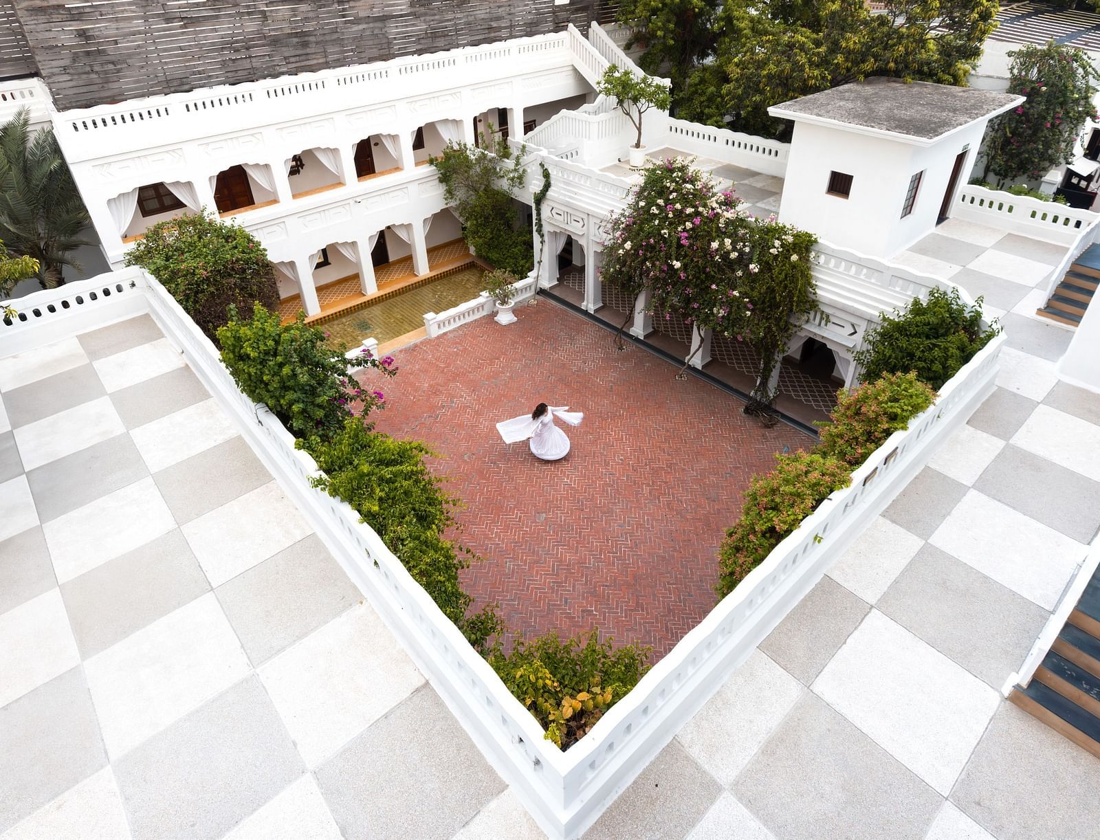 Aerial top view of the open courtyard area of Saraca Hotel, Lucknow with a dining arrangement