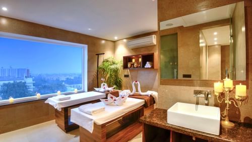 An image of our spa with two comfortable beds and spa amenities placed on shelves - Golden Tulip, Agra