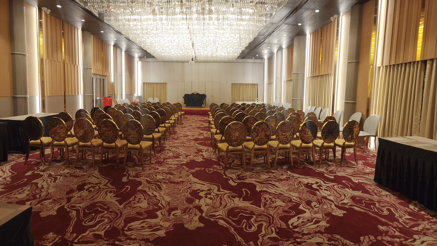 a banquet hall at Lords Inn Rajkot with theatre style seating arrangement and a stage at the front