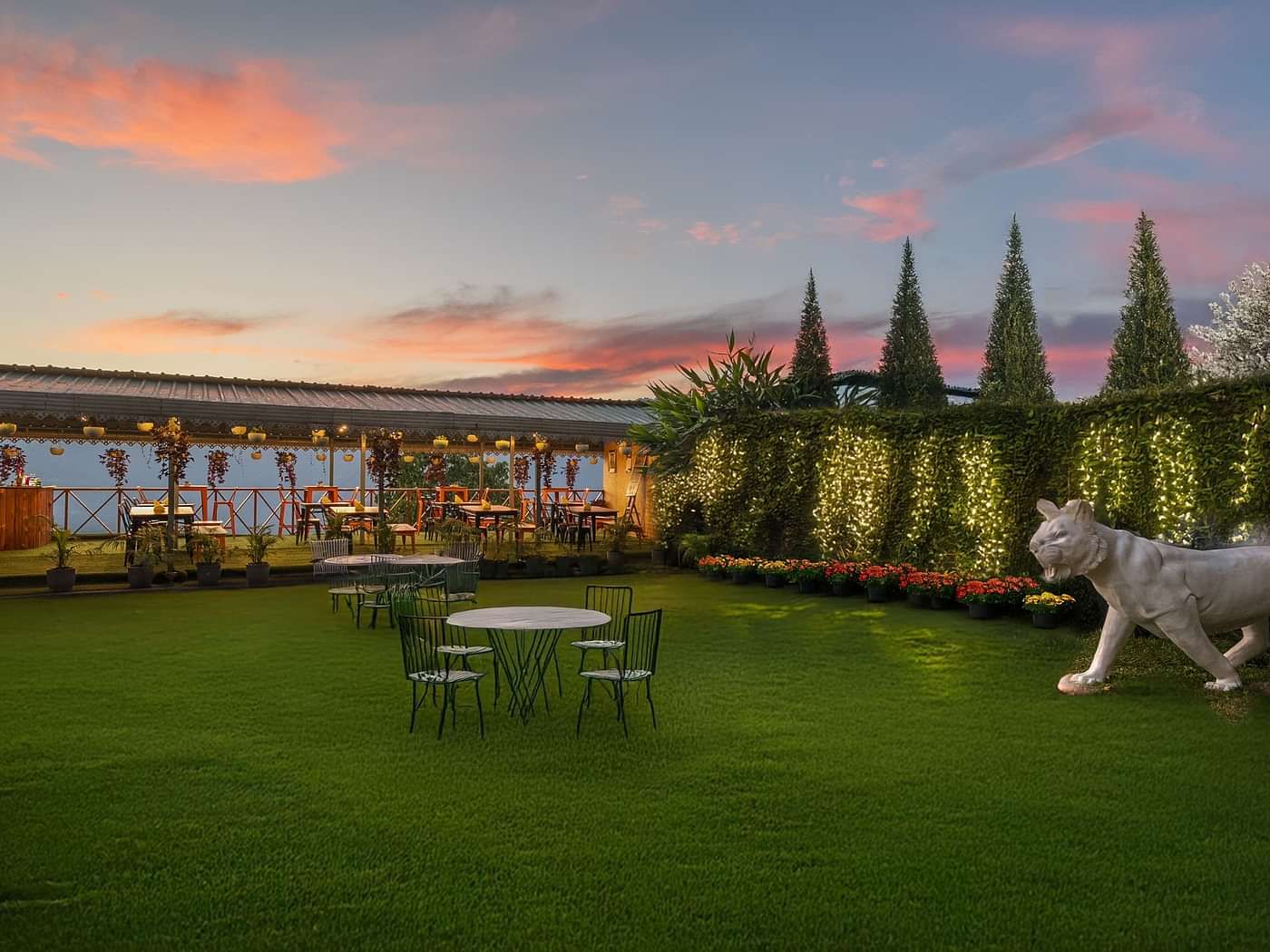 Image of the outdoors of Summit Grand Resort & Spa with plants and trees on the side.