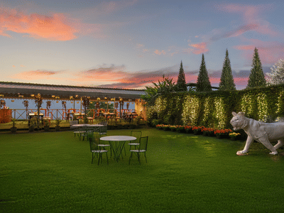 Image of the outdoors of Summit Grand Resort & Spa with plants and trees on the side.