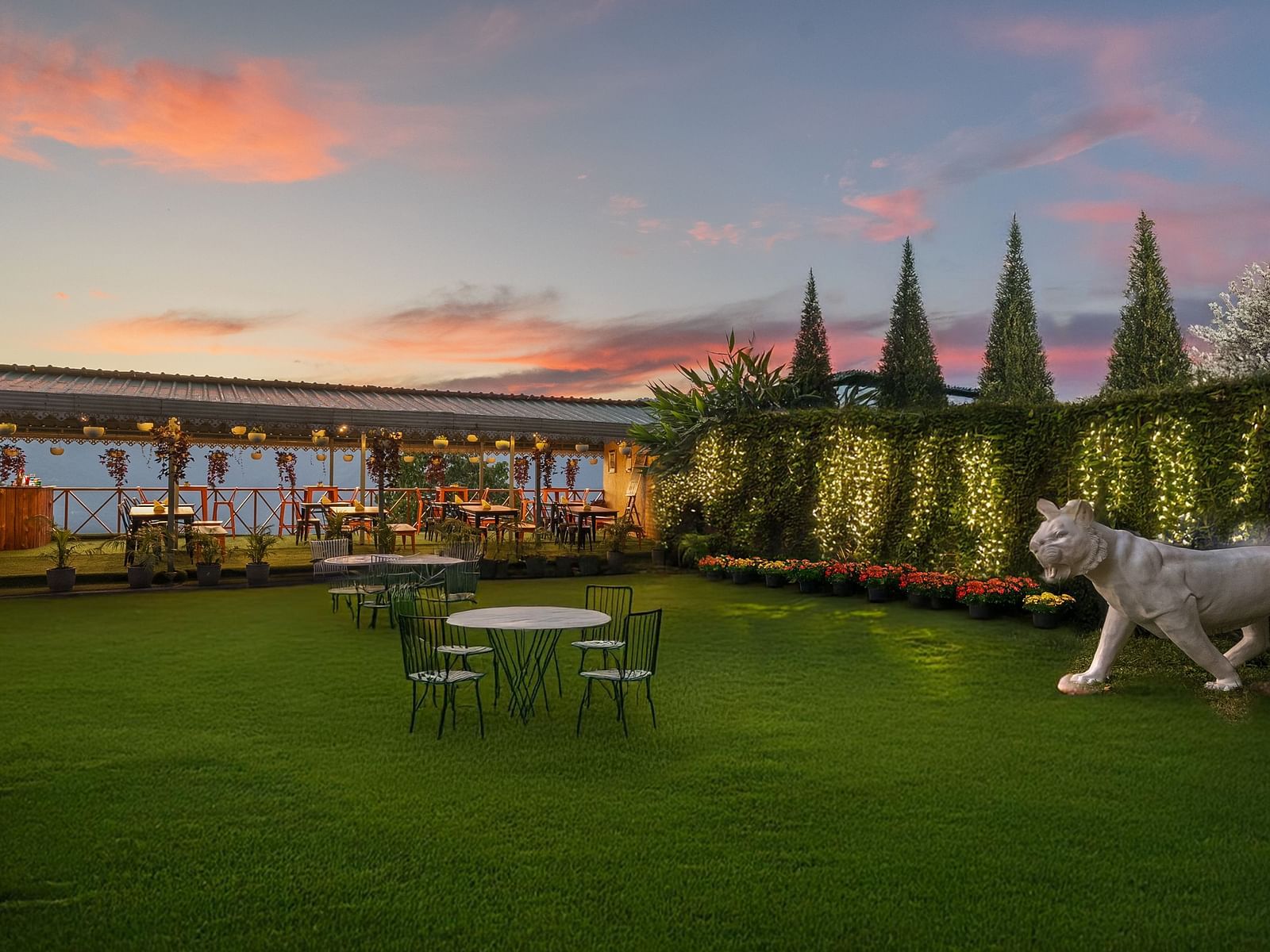 Image of the outdoors of Summit Grand Resort & Spa with plants and trees on the side.