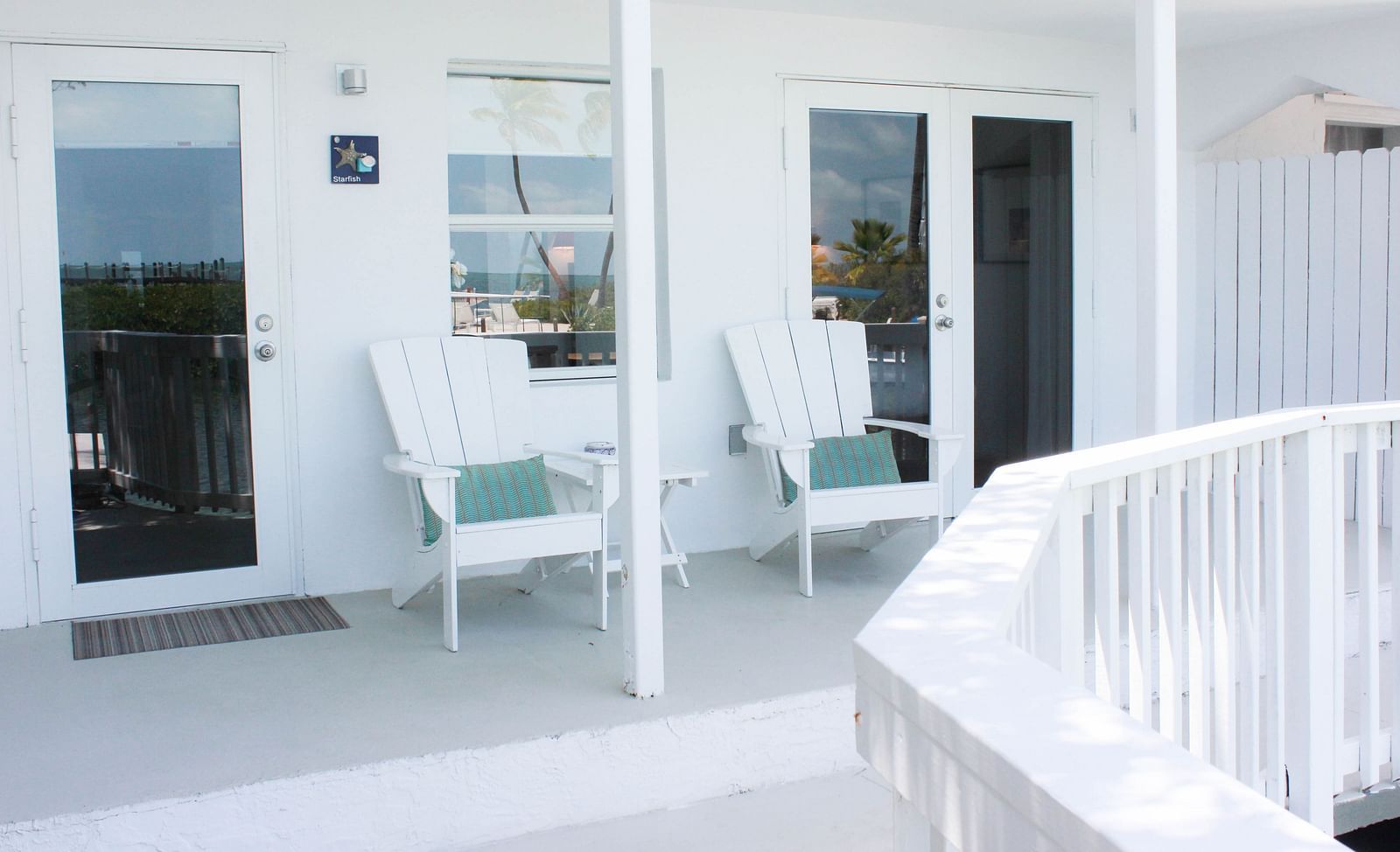 outside sitting area at casa morada with two white chairs and blue cushions. 
