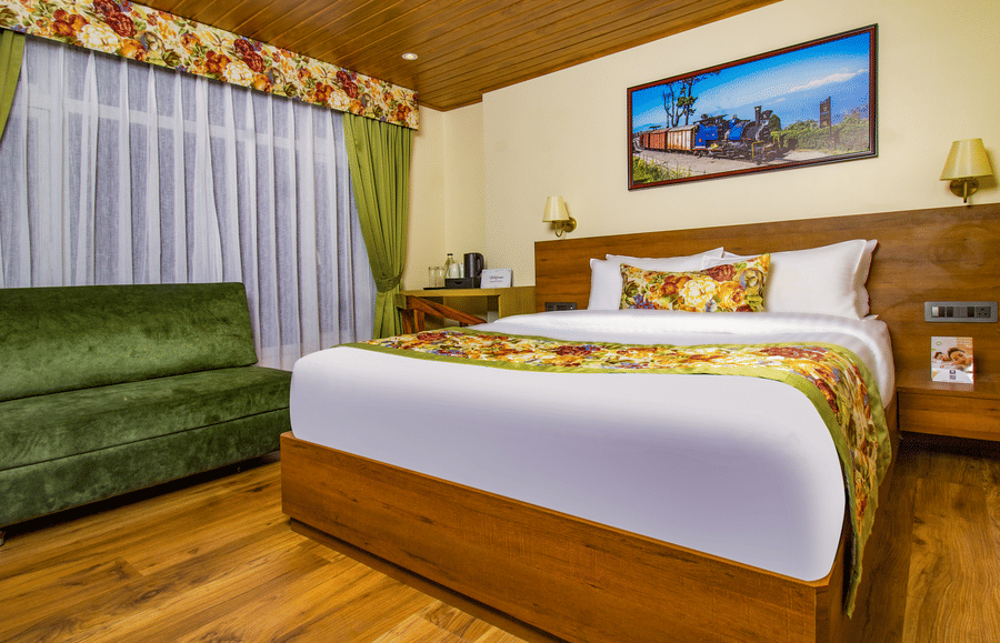 Premium Room featuring warm wooden interiors, king size bed, green sofa seating, and spacious layout | Mount Lungta Boutique Hotel & Spa