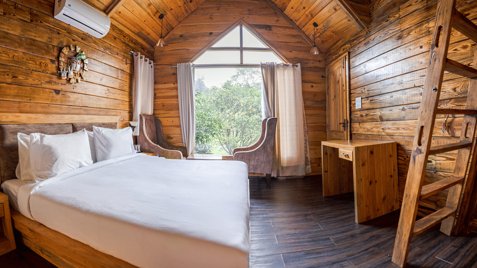A view of the large bed at Pinewood Cottage at the Sylvan Retreat, Dehradun.